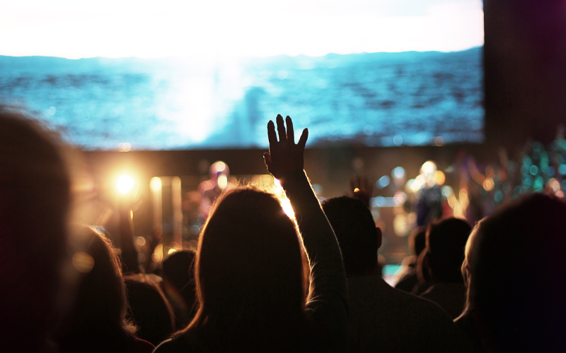 Large church interior with wooden pews, high ceilings, and overhead lighting — typical areas requiring structural, roof, and HVAC inspection.